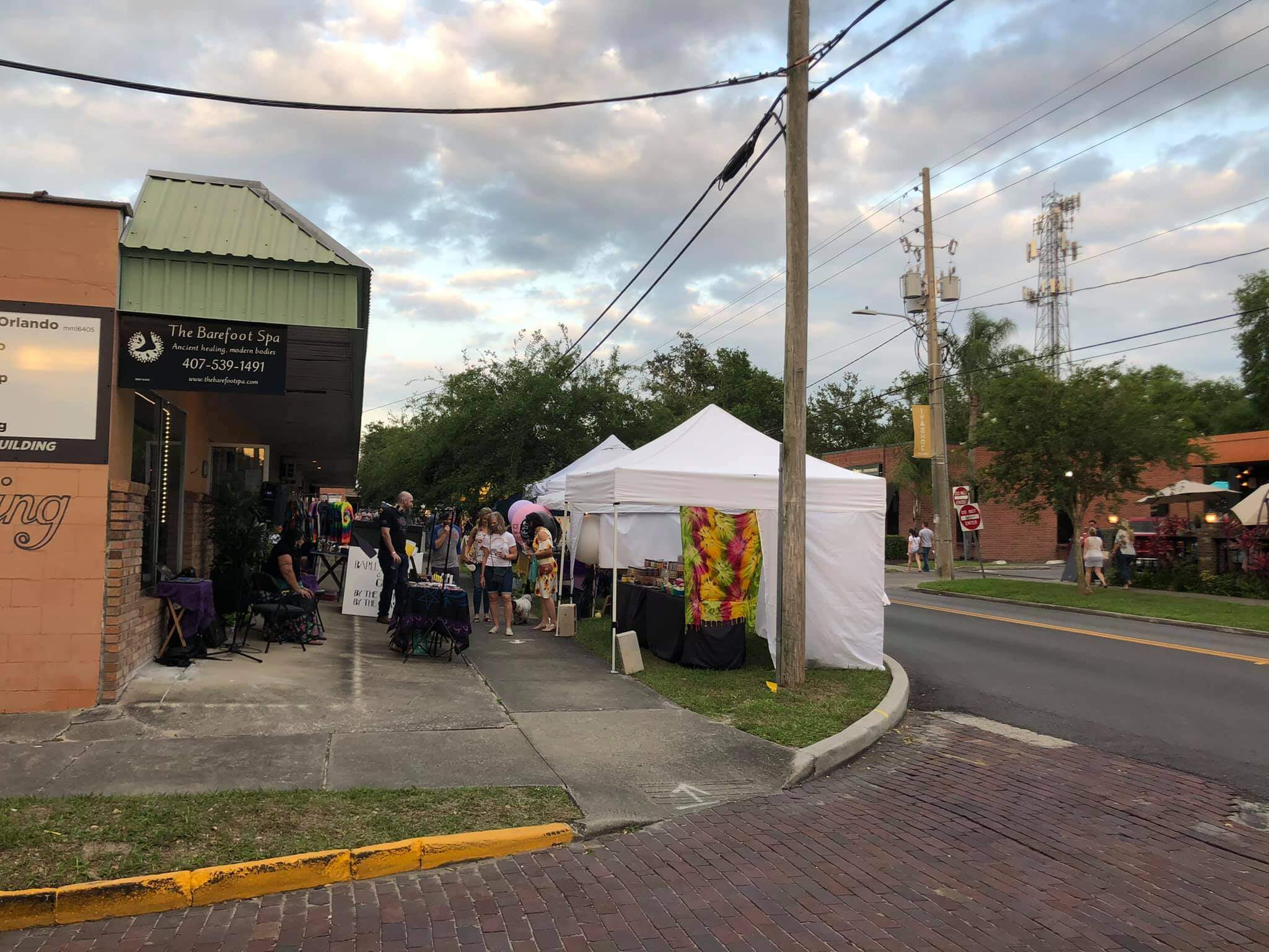 vendors set up on road with cloudy sky