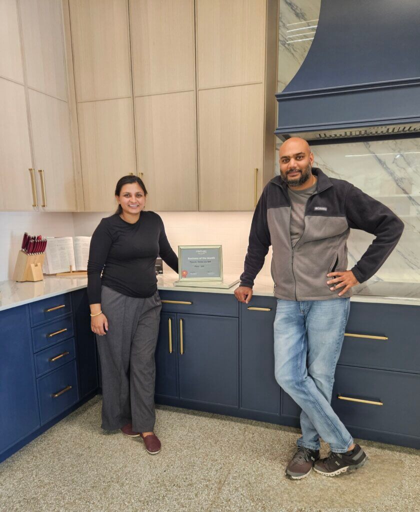 Picture of Dulari and Pat, the owners of Monarch Kitchen & Bath with their Business of the Month sign.